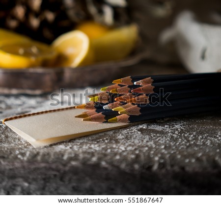 set of colored pencils on a wooden table   background  tropical fruit