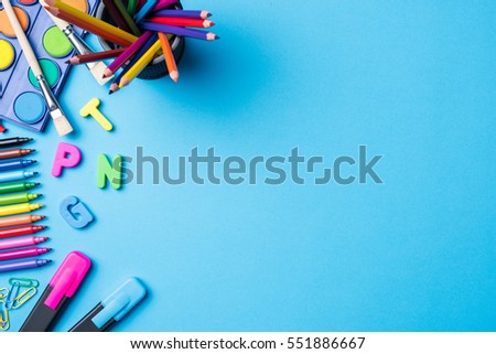 Overhead shot of school supplies on blue background Royalty-Free Stock Photo #551886667