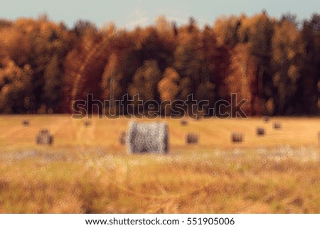 blurred background autumn field haystacks