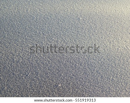 Snow surface background, selective focus, shallow depth of field. Snow sunset.