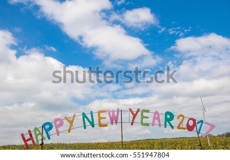 Happy new year logo on beautiful fresh sunflower and blooming with sunrise ,natural background, selective focus