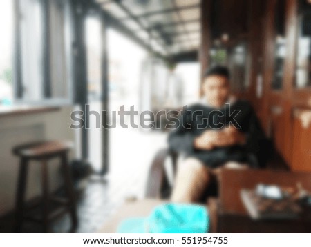 blur human using touch screen tablet phone with Coffee shop blur background
