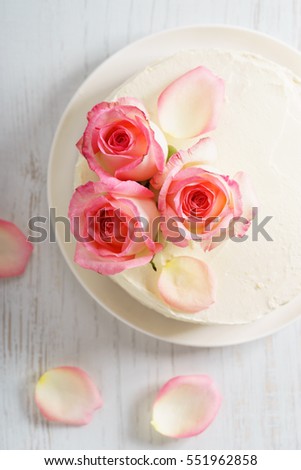 sweet white buttercream round cake with pink rose flowers on top, valentines love concept