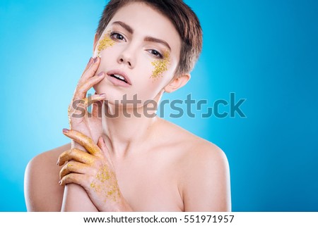 Professioanl attractive model posing against blue background