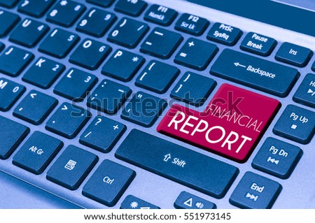 close up on a laptop keyboard with text FINANCIAL REPORT