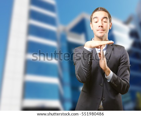 Doubtful businessman with a break time gesture