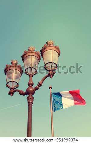 Retro lamppost and French flag in Paris