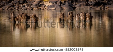 River Pylons and rocky shore with reflections