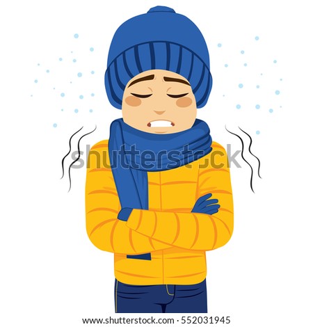 Young man freezing wearing winter clothes shivering