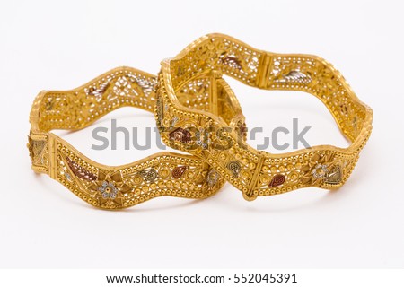 Bengali traditional wedding gold bangles for women in white background. Royalty-Free Stock Photo #552045391