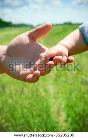 Parent holding little hand
