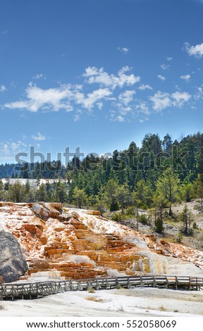Beautiful landscape. Mammoth Hot Springs on a hill of travertine in Yellowstone National Park. Blue sky in the background. Copy space. Wyoming,USA.