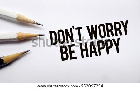 Don't worry be happy memo written on a white background with pencils