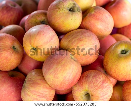 A lot of fresh red apples on street market Royalty-Free Stock Photo #552075283