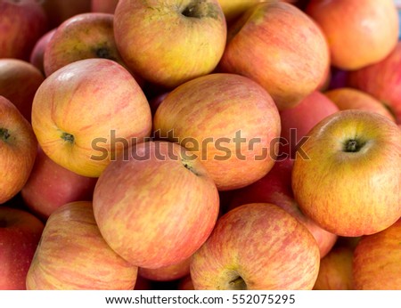 A lot of fresh red apples on street market Royalty-Free Stock Photo #552075295