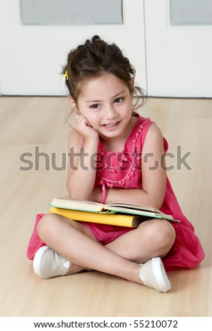preschooler with book in kindergarten Royalty-Free Stock Photo #55210072