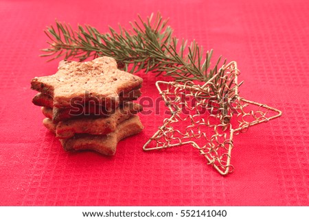 Christmas cookies and holiday decorations on red background