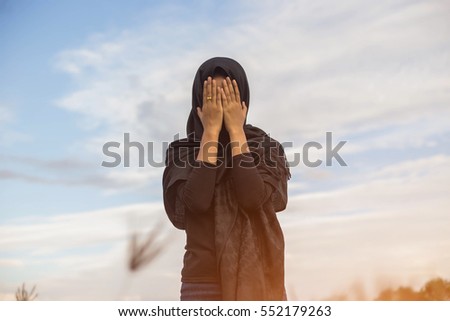  woman praying over beautiful sky background
