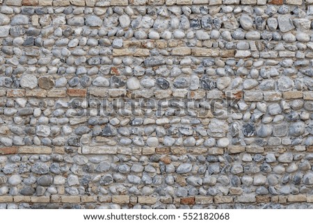 Stonewall made of pebbles and bricks