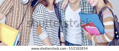 Happy group of students holding notebooks , isolated on white background