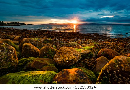Sunset over the sea in Norway over the Arctic coast of Norway Royalty-Free Stock Photo #552190324