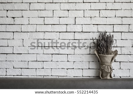 lavender flowers on white brick wall background with vintage toned style