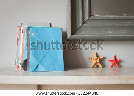 Envelopes and starfish on mantelpiece