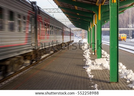 Train station in winter. Temperature -20Â°C. Train is leaving
