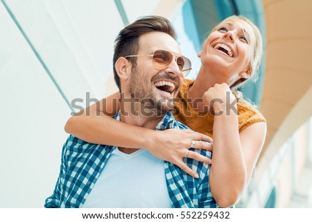 Happy couple in love having fun outdoors and smiling. Royalty-Free Stock Photo #552259432