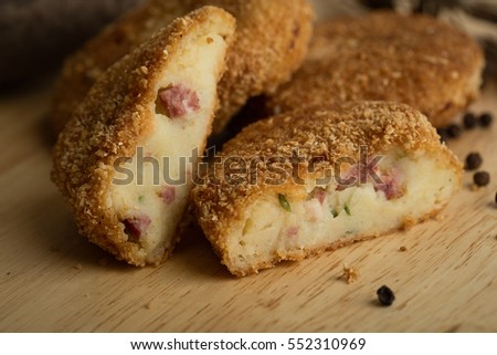 Pille of crispy homemade baked fast food potatoes nuggets with chicken shrimp and cheese