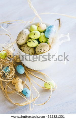 Table setting for Easter dinner with eggs on white wooden table