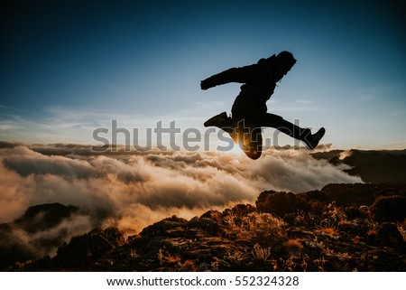 man jumping above clouds, sunset, kilimanjaro national park, mountains