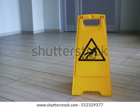 Yellow sign that alerts for wet floor indoors