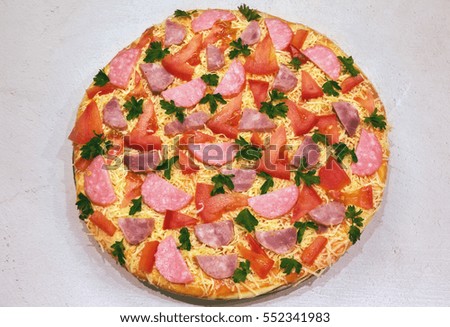 pepperoni pizza with  salami, parmesan cheese and tomato