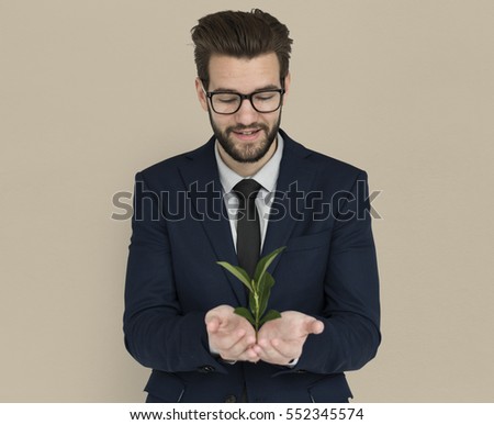 Caucasian Business Man Holding Seedling