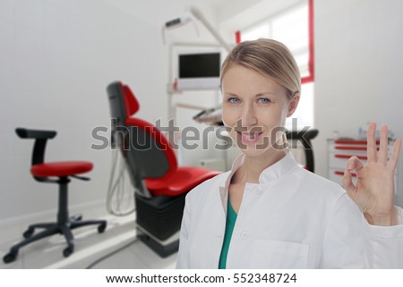 Smiling Female doctor dentist showing Ok or Alright Sign.