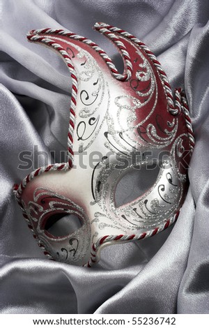 Carnival mask over gray satin