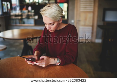 Beautiful international student hipster girl reading online manual book via special application for digital devices installed on touchpad connected to wifi in cafe copy space for your advertising