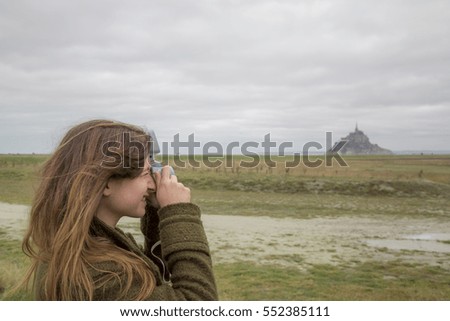 Beautiful handsome Girl taking photo, Le Mont Saint Michel Abbey, Normandy / Brittany, France