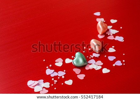 A little soap in heart shape with red background theme of Valentines Day.