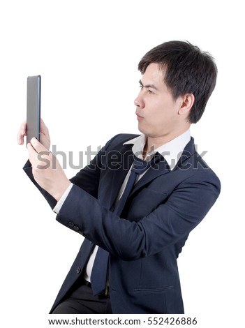 businessman asian look a Tablet , man black suit & necktie