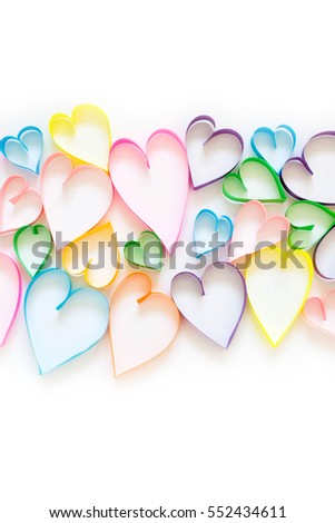 Bright colored hearts made of paper. White background.