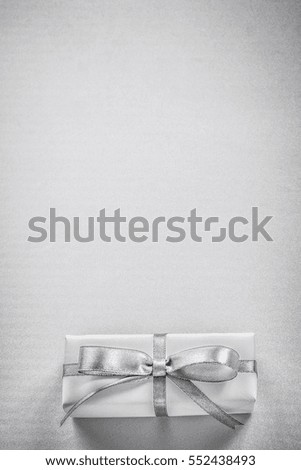 Wrapped gift box on gray background copyspace holidays concept.