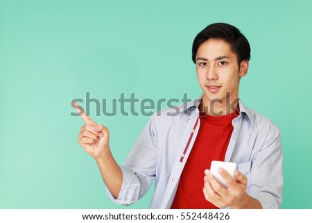 Asian man holding a smart phone 	