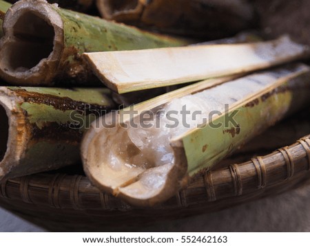 Glutinous rice roasted in bamboo joints finished in basket. This is a part of cooking process of glutinous rice roasted in bamboo joints. Picture from Thailand country.