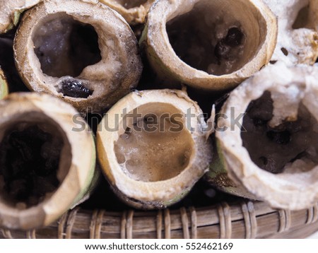 Glutinous rice roasted in bamboo joints finished in basket. This is a part of cooking process of glutinous rice roasted in bamboo joints. Picture from Thailand country.