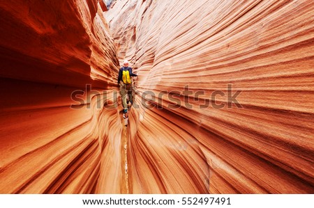 Slot canyon in Grand Staircase Escalante National park, Utah, USA. Unusual colorful sandstone formations in deserts of Utah are popular destination for hikers. Royalty-Free Stock Photo #552497491