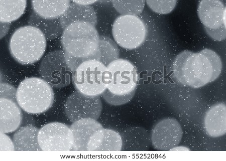 Snowflakes particles and bokeh or glitter lights on silver background. Abstract template