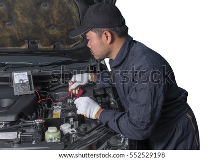 Professional Auto mechanic uses a voltmeter to check the voltage level of a Car Fuse box, Control engine lighting. Car electrical isolated on white background with clipping path
