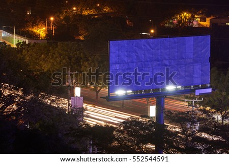 Empty banner in city at night with traffic on highway